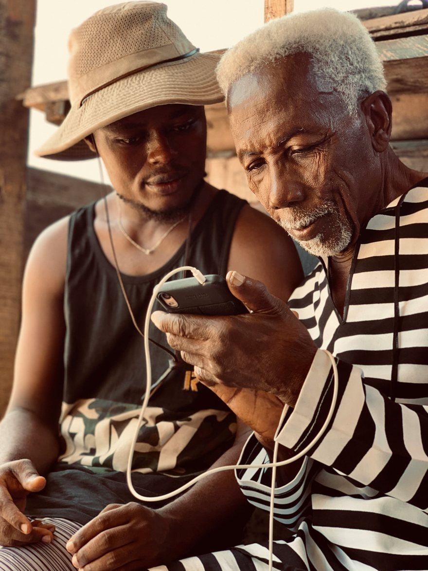 A traveller showing their phone to someone abroad
